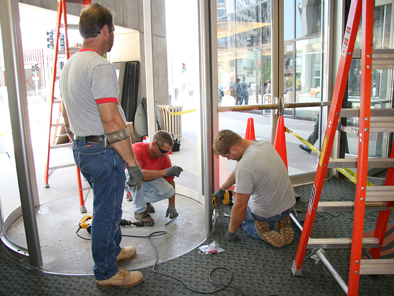 installation-crew-retrofits-carpet-around-revolving-security-door
