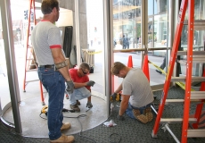 installation-crew-retrofits-carpet-around-revolving-security-door