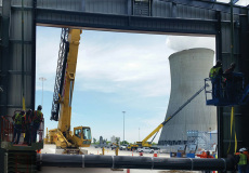 installation-crew-orchestrates-positioning-large-commercial-door-with-a-crane