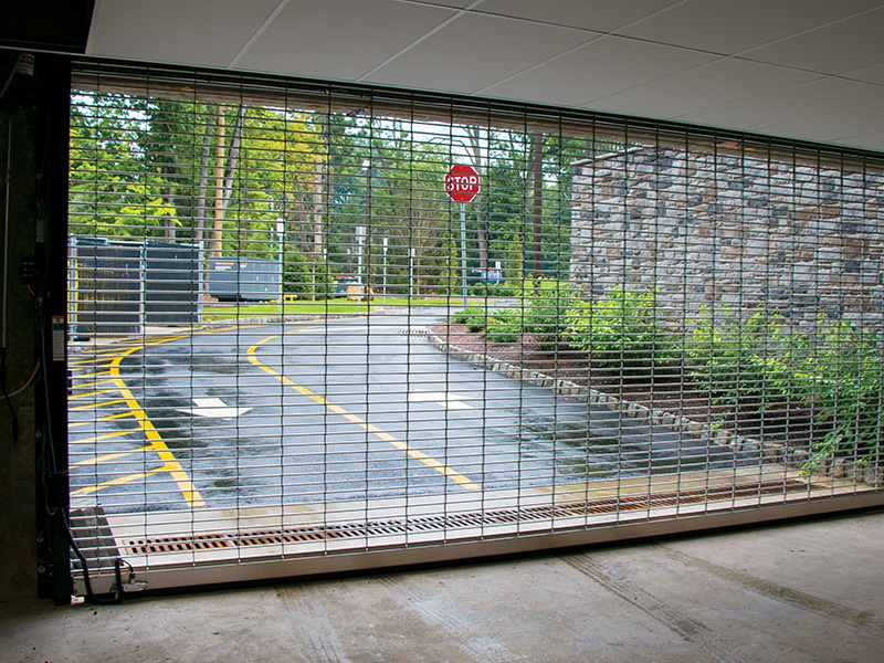 rolling-steel-security-grille-secures-parking-garage-entrance