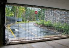 rolling-steel-security-grille-secures-parking-garage-entrance