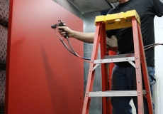 technician-professionally-paints-doors-in-full-service-in-house-paint-booth