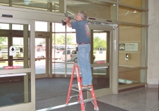 door-technician-performing-planned-maintenance-on-automatic-sliding-door