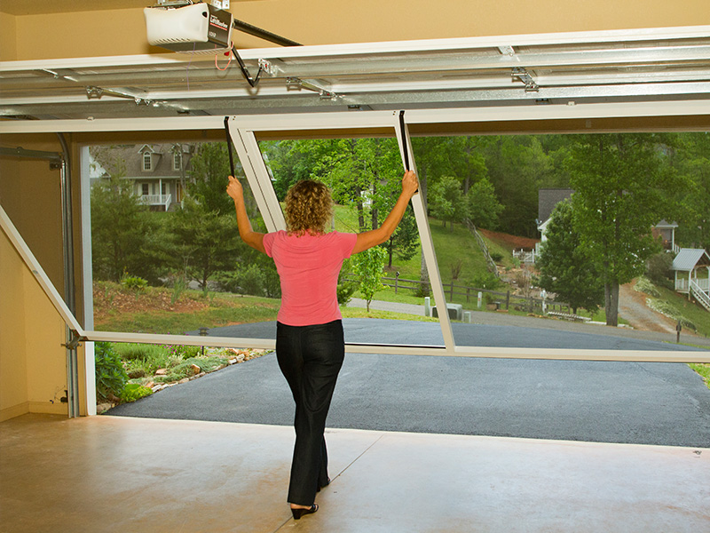 Woman putting garage door screen in place
